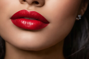 Fototapeta premium Close-up of beautiful lips with red lipstick