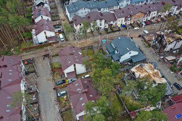 Hostomel, Kyev region Ukraine - 09.04.2022: Top view of the destroyed and burnt houses. Houses were destroyed by rockets or mines from Russian soldiers. Cities of Ukraine after the Russian occupation. - 697166956