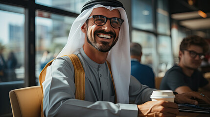 Happy Emirati Arab at office wearing Kandura - obrazy, fototapety, plakaty