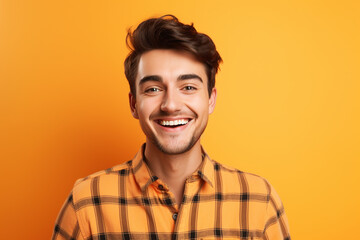 Obraz premium handsome bearded posing against wearing check orange shirt on orange background