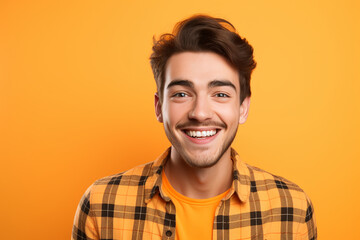 Fototapeta premium handsome bearded posing against wearing check orange shirt on orange background