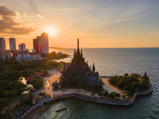Skyline of Pattaya city at sunset with The Sanctuary of Truth wooden temple in Pattaya Thailand,...