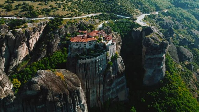 Flying over Meteora Monasteries, Greece. Landscape scenery with green hills, rocks, and old Monasteries on it.