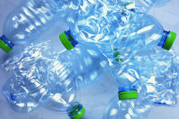 Used plastic water bottles with green caps are going to be recycled.