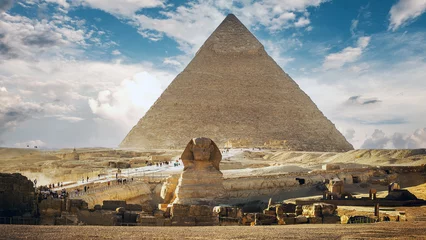 Foto op Canvas Landscape with Egyptian pyramids, Great Sphinx and silhouettes Ancient symbols and landmarks of Egypt for your travel concept to Africa in golden sunlight. The Sphinx in Giza pyramid complex at sunset © khan