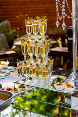 A Table Filled With Champagne Glasses. A table topped with lots of glasses filled with champagne