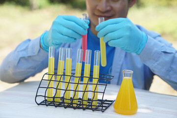 Colorful chemical substance in test tubes that chemist is mixing outdoor.Concept, outdoor teaching...