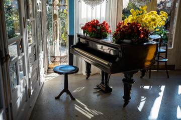 Vintage interior of classic style music room with grand piano, big window, luxury chandelier....