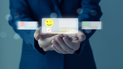 Woman's hands choosing on the happy Smile face icon to give satisfaction in service for feedback...