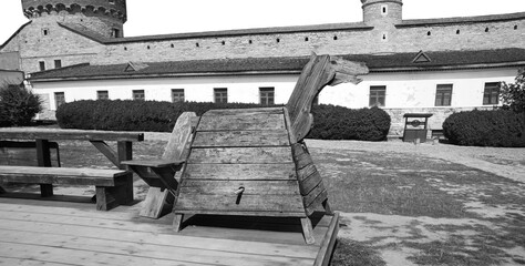 Kamyanets-Podilsky citadel tourism museum, Ukraine. 12 may 2023.  Old wooden horse for punishment...