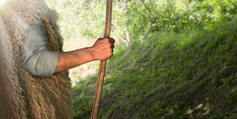 Man's hand with a wooden rod