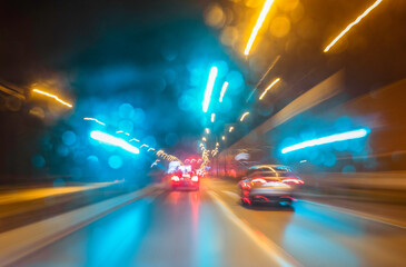 City colorful night lights perspective blurred by high speed of the car. A streak of light, trails.
