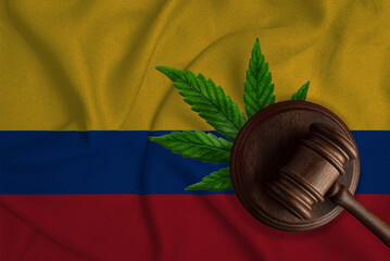Flag of Colombia and justice gavel with cannabis leaf. Illegal growth of cannabis plant and drugs...