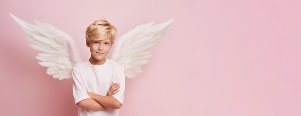 A smiling boy with delicate angel wings on a pink background, a place to copy.
