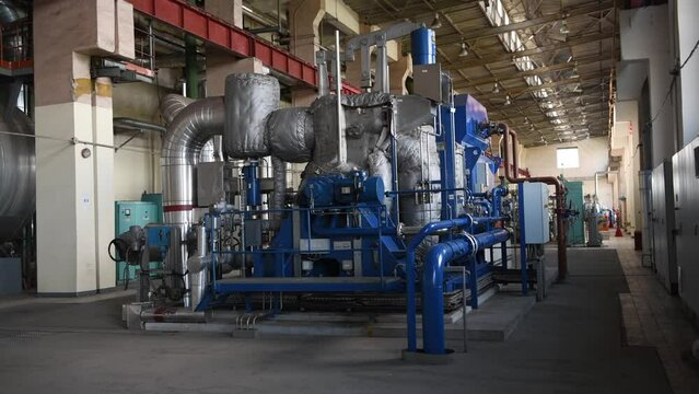 Industrial machines. Internal structure of large thermal power plant. The interior of an industrial boiler room with many pipes, valves and sensors. Lithuania, Vilnius