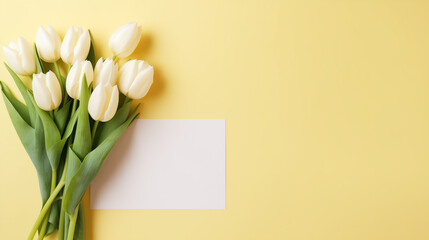 pale yellow background with a bouquet of white tulips and a greeting card, free space for text