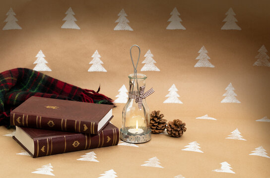 Christmas composition – candleholder, books and blanket.