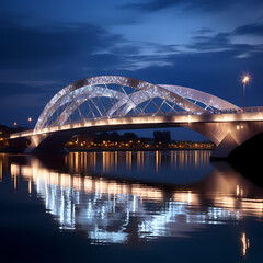 Modern bridge with lights reflecting in the calm water below