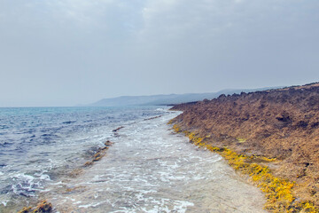 Harmony of Land and Sea: Rimel's Mountainous Landscape Meets Tranquil Beach in Bizerte, Tunisia