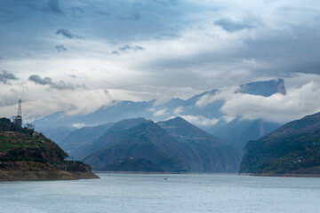 A serene view of the Yangtze River surrounded by misty mountains, captured in Longhui Flower Valley, Fengjie County, China on March 17, 2018.