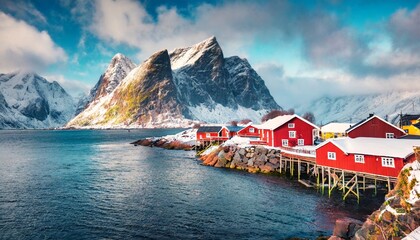 attractive morning scene of sakrisoy village norway europe bright winter view of lofoten islads witj typical red wooden houses beautiful seascape of norwegian sea traveling concept background