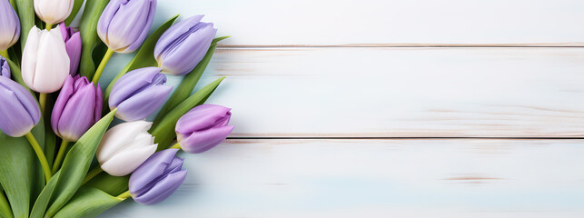 Bouquet of tulips on wooden background. Top view with copy space