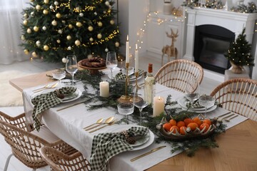 Christmas table setting with festive decor and dishware in living room