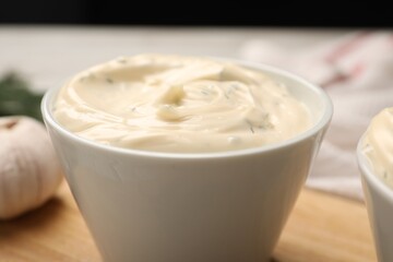 Tasty garlic sauce in bowl on table, closeup