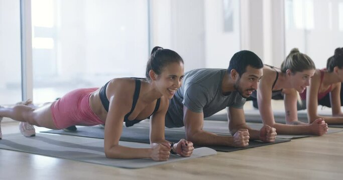 Group, planks or people in gym for fitness workout, body exercise or healthy wellness together. Diversity, teamwork or sports athletes in aerobics class for training core or strong abs with energy