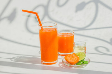 A glass of healthy carrot juice with ingredients