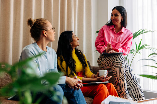 Female entrepreneurs discussing while sitting together at office
