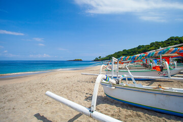 Virgin beach or White Sand beach in Bali, Indonesia with wooden fishing boats on the sand