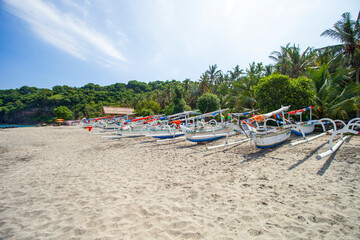 Virgin beach or White Sand beach in Bali, Indonesia with wooden fishing boats on the sand