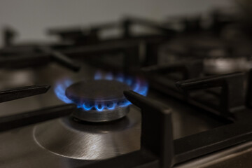 Gas burner on kitchen stove for cooking with fire, energy concept