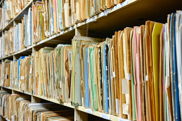 Old medical records on a shelve - obrazy, fototapety, plakaty
