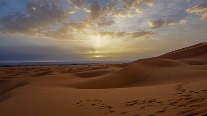01_Sunrise of the famous and legendary dunes of Erg Chebbi in the Sahara Desert, Morocco.
