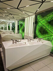 modern public toilet interior. public bathroom with sinks and wide wall mirrors
