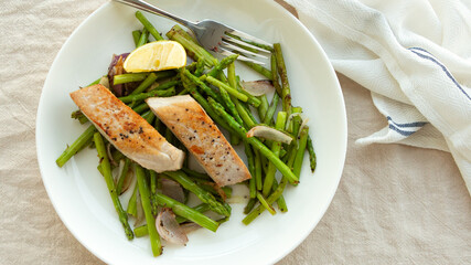 tuna fillet and asparagus on a plate on the table