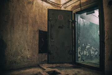 Scary interior of an abandoned bunker. Shabby walls. Low light. Dark abandoned bunker.