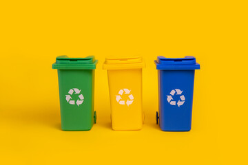 Garbage cans on yellow background