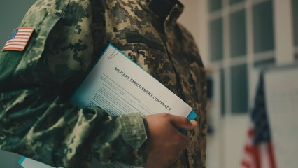 U.S. soldier holding military employment contract, military professions for hire - Powered by Adobe