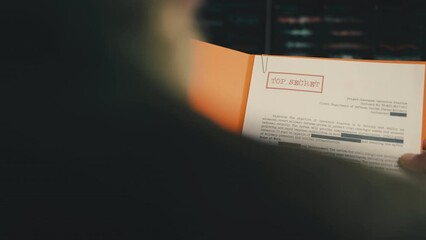 General reading top secret military documents, classified information, report