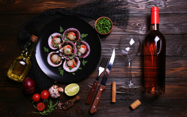 Fresh scallops with a bottle of rose wine with spices and vegetables