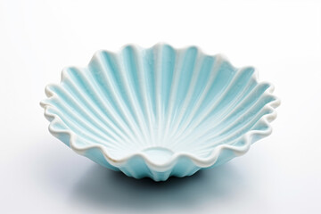 a white bowl with a blue shell design