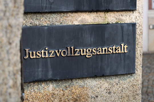 Justizvollzugsanstalt (prison) sign in Germany. The term is also abbreviated as JVA. Criminal people get locked up in this facility. Building exterior of the government to produce justice.