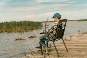 Young Boy Contemplating by Quiet Lakeside, Finding Solace in Nature's Stillness