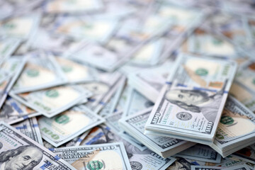 Very big amount of US hundred dollar bills close up. Huge quantity of united states currency notes on flat table