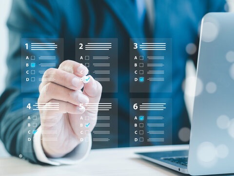 assessment survey online. Businessman with evaluating questionnaire on online laptop computer. choose correct answer in test, questions test, online exam, quiz knowledge, filling out an survey form.