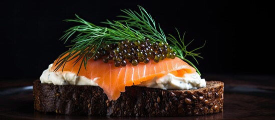 Smoked salmon, cream cheese, and caviar on pumpernickel bread with dill.