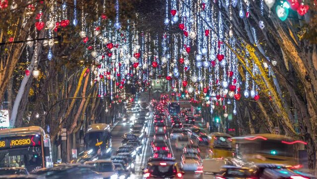 Avenida da Liberdade in Lisbon illuminated with lights hanging from the trees night timelapse. European street decorated for Christmas celebration. Traffic on the road during holiday evening. Portugal